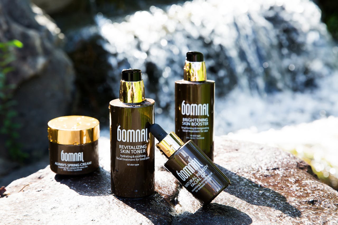 High-end skincare products showcased by a natural waterfall for a refreshing appeal.