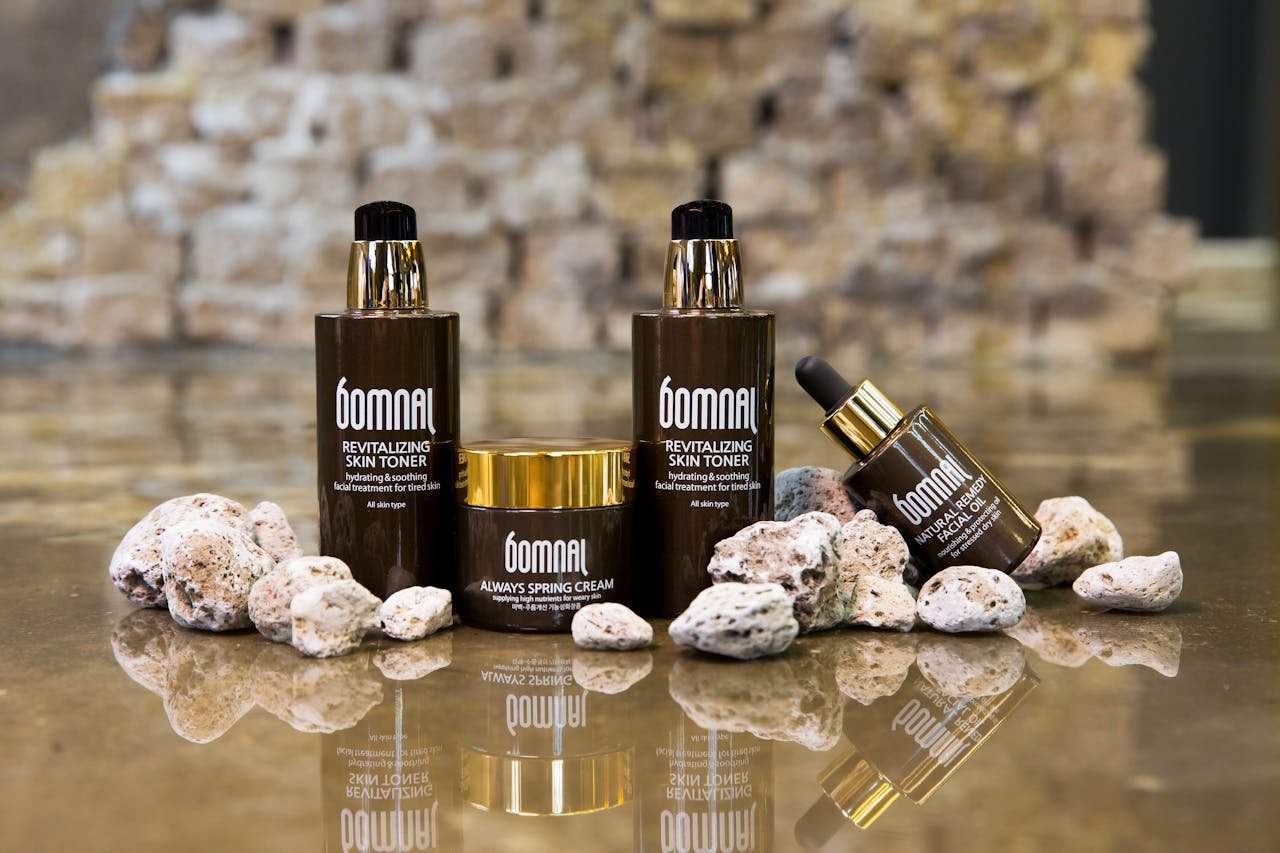 Elegant skincare product setup with reflective surface, ideal for beauty ads.